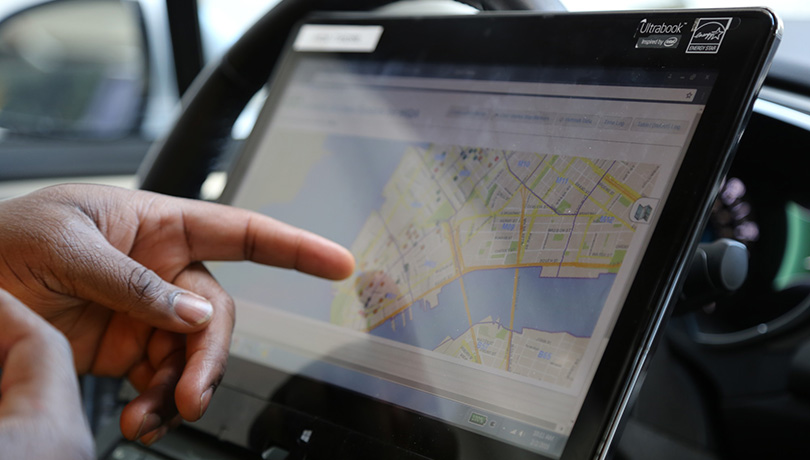 Person pointing to a map on a tablet