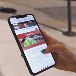 A person viewing the Pedestrian Ramp Program website on an iPhone